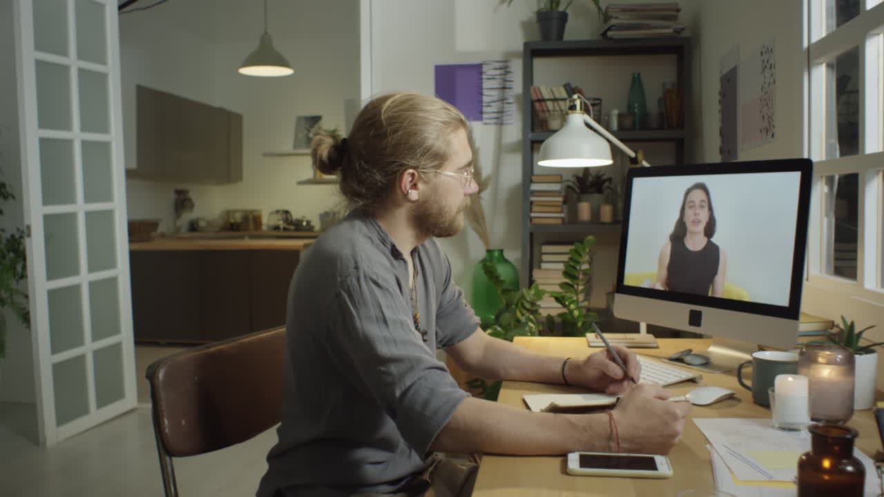 Man Studying Online in Evening at Home