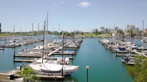 aerial shot from luxury hotel resort to yacht marina with boats at dock