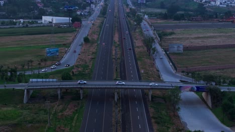 aerial descend tilt up of highway leading to puebla mexico city skyline