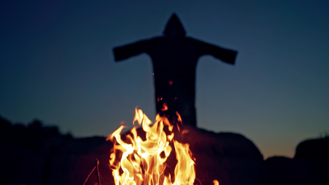 Evil witch conjures in the wizarding lair. Scary Halloween concept. Burning fire.