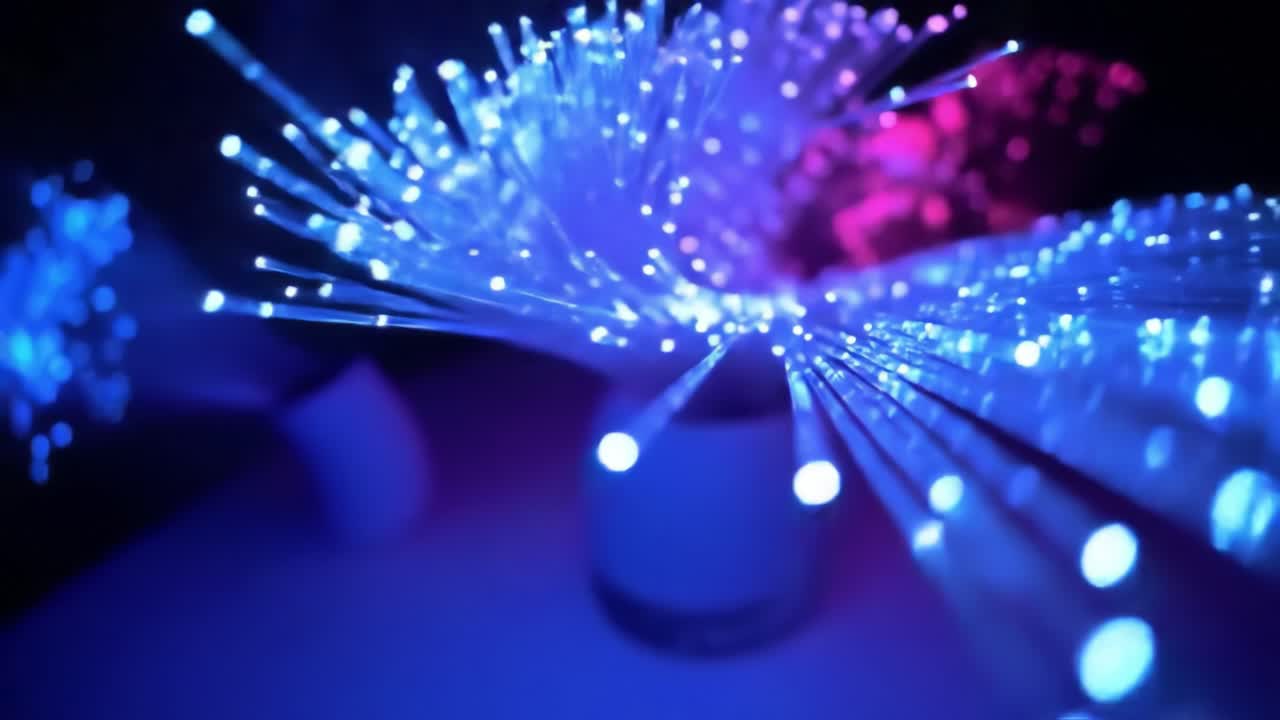 Colorful fiber optic strands light up a dimly lit space, producing a stunning array of blue and pink lights. This captivating setup creates a vibrant atmosphere ideal for relaxation and enjoyment.