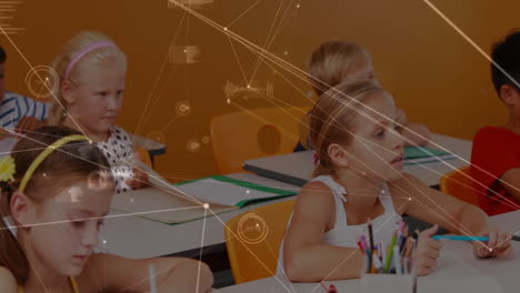 primary school students writing in classroom, showing notebooks and digital network graphics
