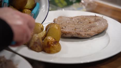 grilled steak dish with potatoes being added to the dish