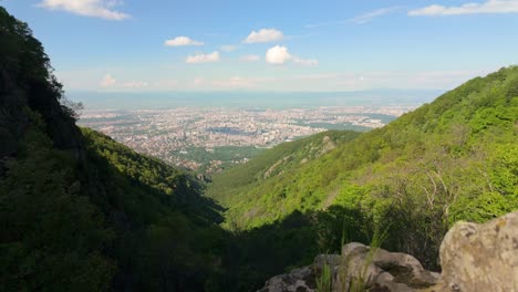 beautiful mountain foreground with a city in the background on a bright sunny day