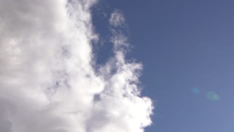 Huge-White-Clouds-On-A-Beautiful-Blue-Sky,-Crane-Shot