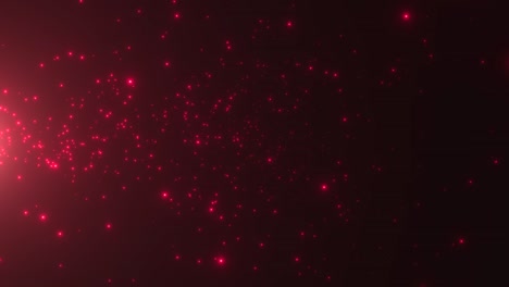 pequeñas partículas rojas y estrellas en fondo oscuro