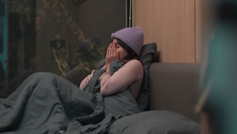 indonesian girl feeling cold inside a cozy room