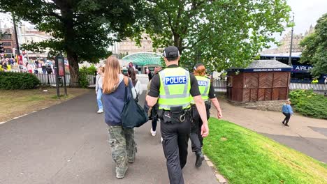 police officers walking through a crowded park