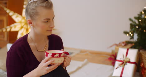 thoughtful woman sitting with coffee cup at home 1