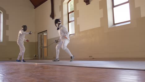 fencer athletes during a fencing training in a gym