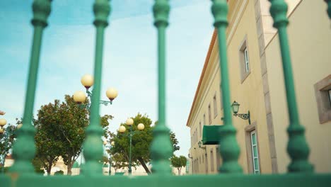 Mansion-facade-with-public-lamp-through-iron-fences-truck-shot-4K