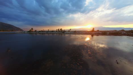 Panning-over-a-still-freshwater-lake-to-sunset