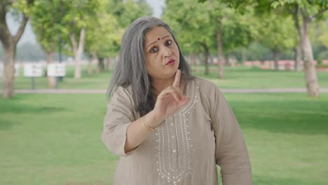 Angry-Indian-old-woman-saying-No-and-stopping-someone-in-park