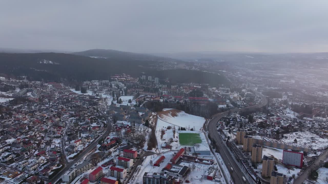Bjerke Arvoll Tonsengagen Oslo Norge Norway Skikurs skisenter aerial drone cold cloudy winter day gray skies city neighborhood buildings landscape Arctic circle snowing forward motion