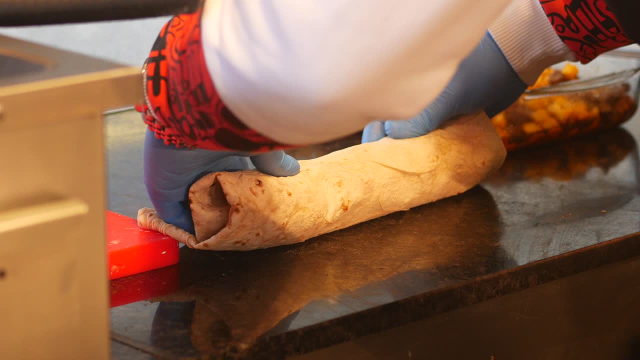 Preparing a delicious wrap with meat and fries