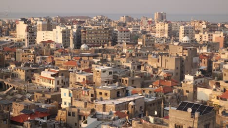 aerial panning view of old arab town with mosque and minaret in tripoli, northern lebanon