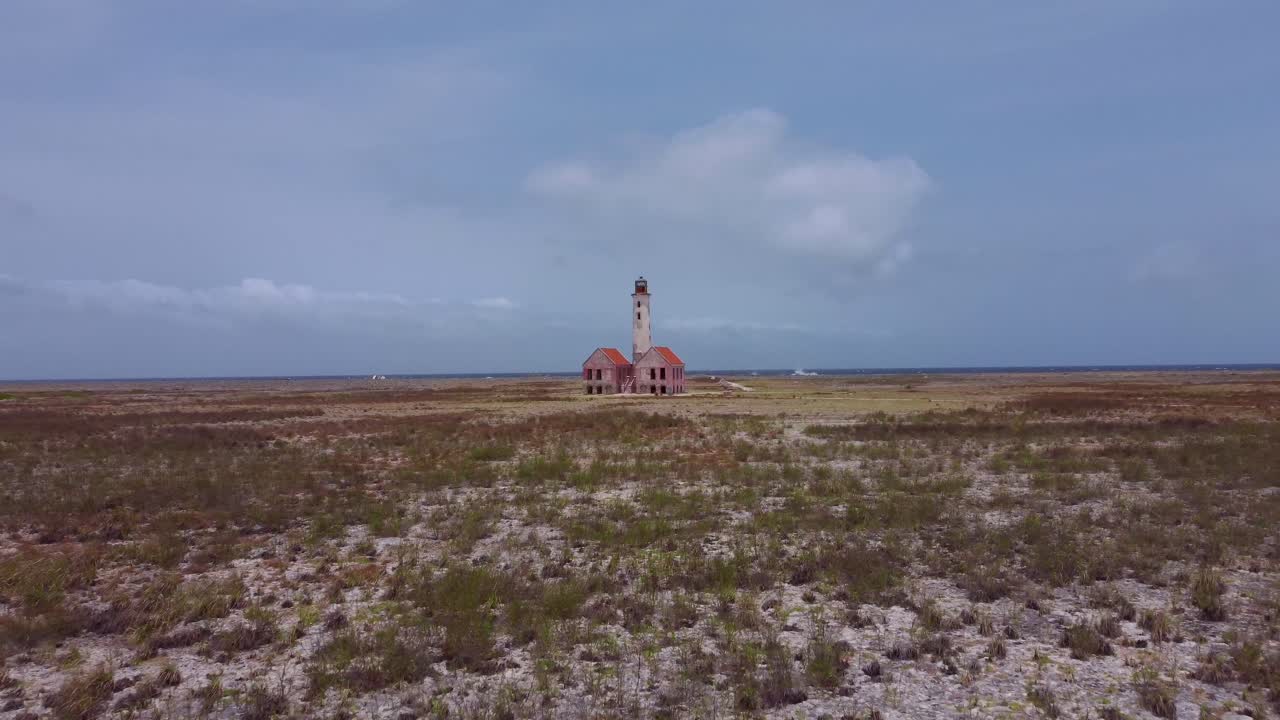 Aerial Drone Away from Abandoned Isolated Historic Light Tower on flat land