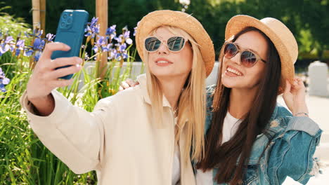 two women taking a selfie outdoors