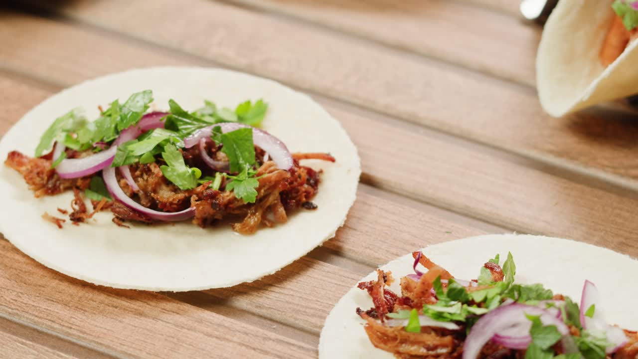 Delicious Carnitas Tacos on a Wooden Table
