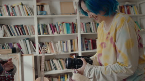girl filming her boyfriend drinking wine at home recording studio
