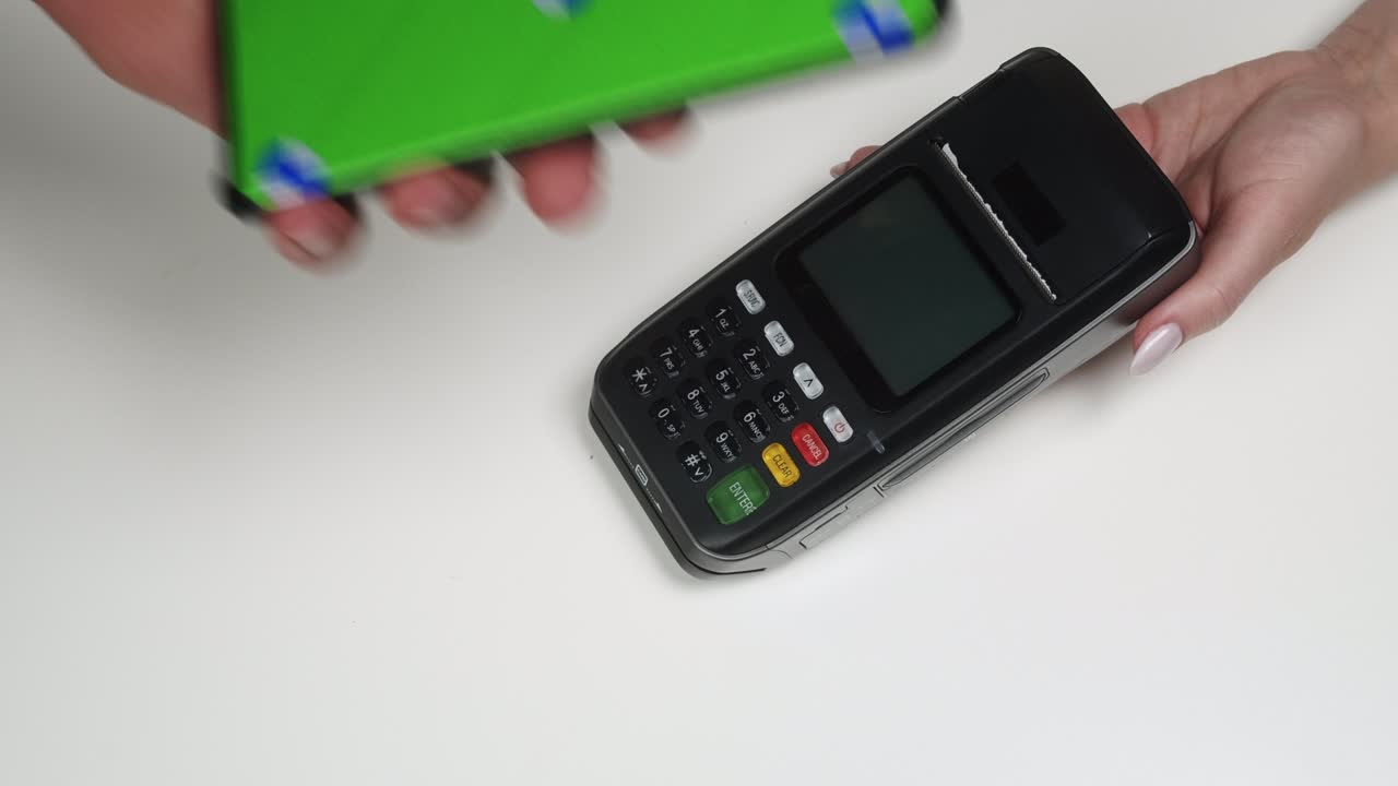 Payment by smartphone with chroma green screen via terminal without entering the PIN code, contactless paying while shopping to observe safety protection, using mobile phone making transaction