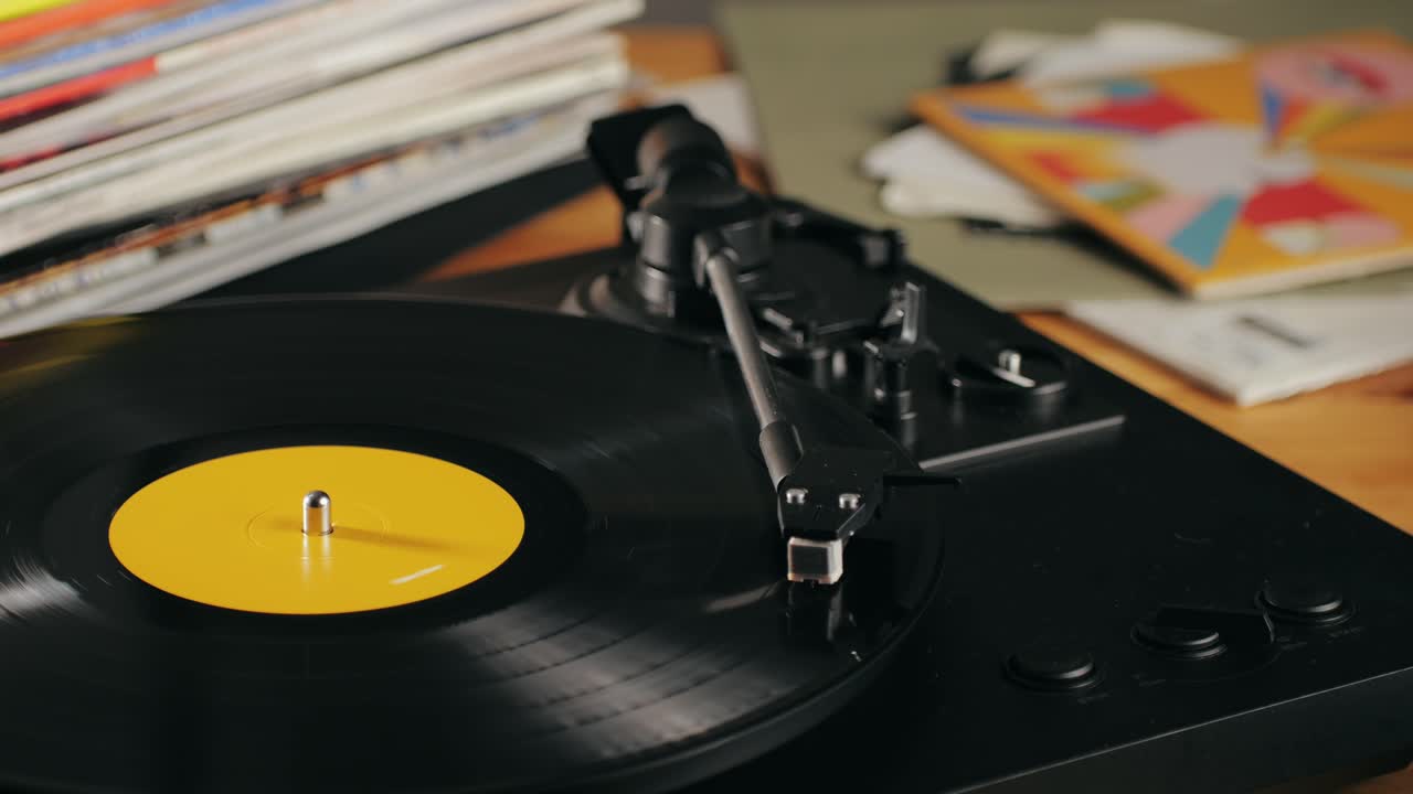 Retro Vinyl record player playing music, close-up macro shot of vintage LP disc old phonograph spinning. Retro music player.