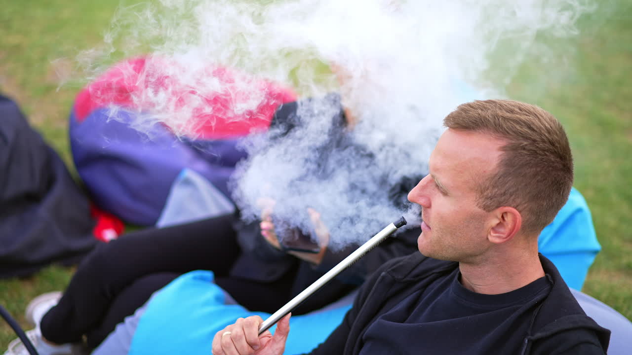 Couple Smoking Hookah Outdoors
