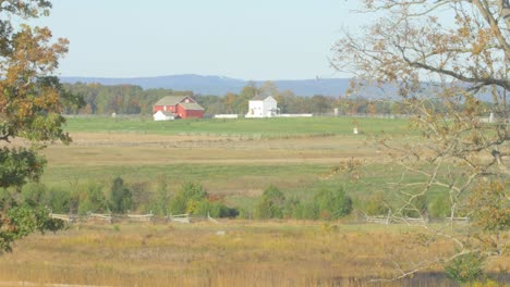 the landscape of the fields of gettysburg with the famous red farm