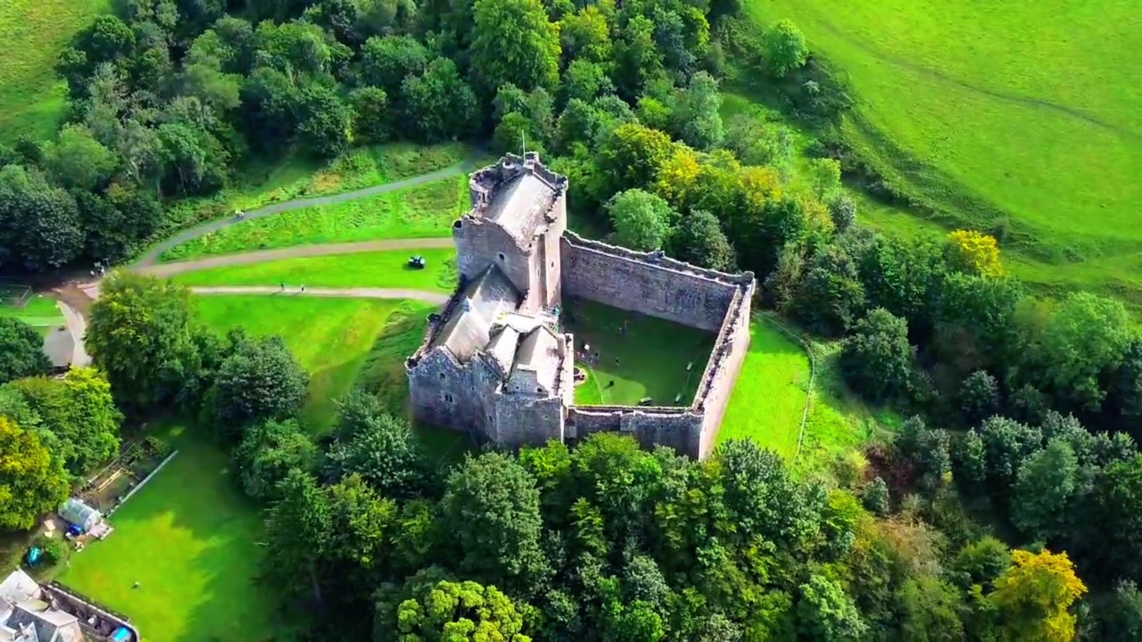 Orbital aerial view, Doune Castle in Scotland. Famous medieval fortress surrounded by lush green landscape, a popular filming location and heritage tourism landmark