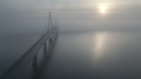 Concept-of-Crossing-over-into-the-unknown,-aerial-shot-of-car-over-bridge