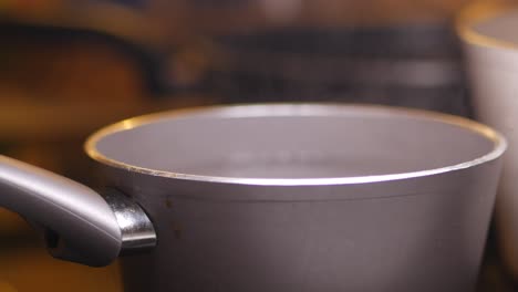 closeup of a pot of boiling water on a stove