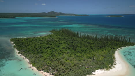 Aerial-low-altitude-pull-back-revealing-amazing-Ilot-Moro,-and-Isle-of-Pines-in-the-background