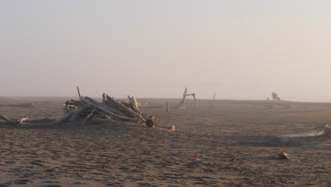 two people sit on bullards beach with a misty golden haze