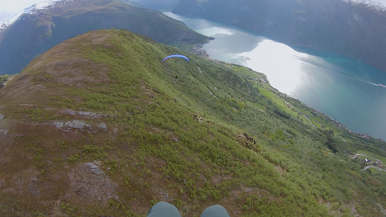 Speedflying down a mountain in Aurland in Norway. Speedfying is a small paraglider wing. This is a POV shot of the flight.