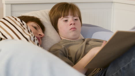 teenager reading magazine on bed with her mother