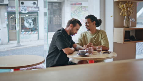 two gay men flirting at romantic meeting in cafeteria. couple partners talking