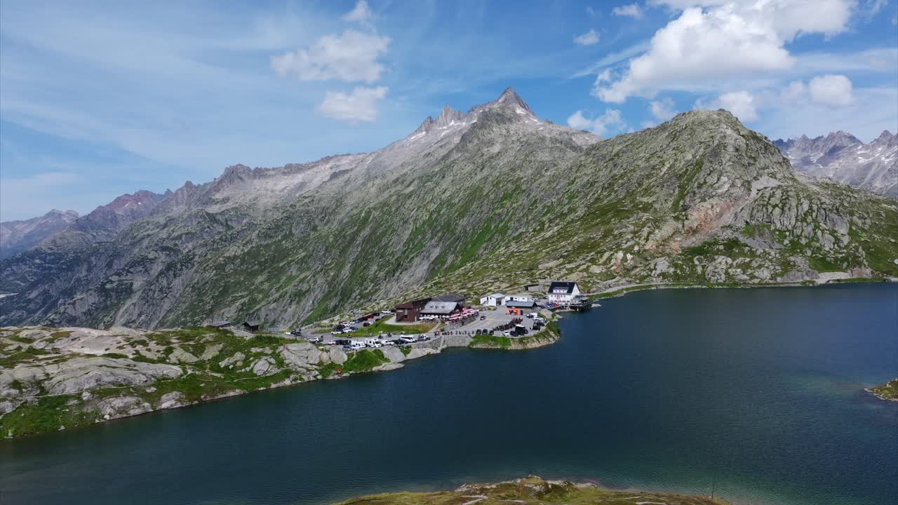 Aerial view of Totensee Lake surrounded by majestic Alps mountains in Switzerland, showcasing natural beauty and scenic tranquility.