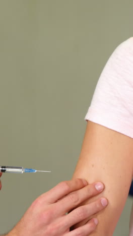 male therapist injecting female patient