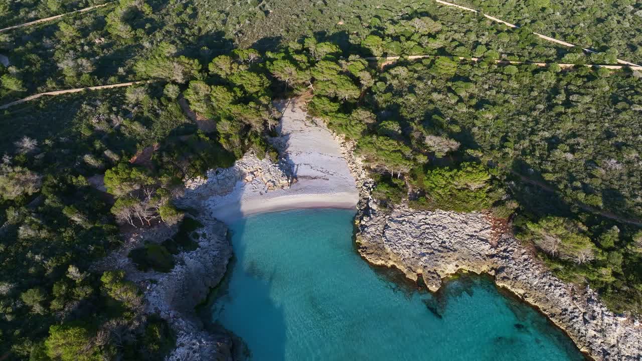 Aerial view of Es Talaier virgin beach with clear blue water in Menorca Spain