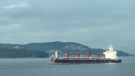cargo vessel anchored peacefully off vancouver island.