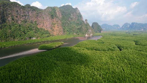 drone flying over ao thalane mangroves and river in krabi thailand on a sunny day overlooking the mountains