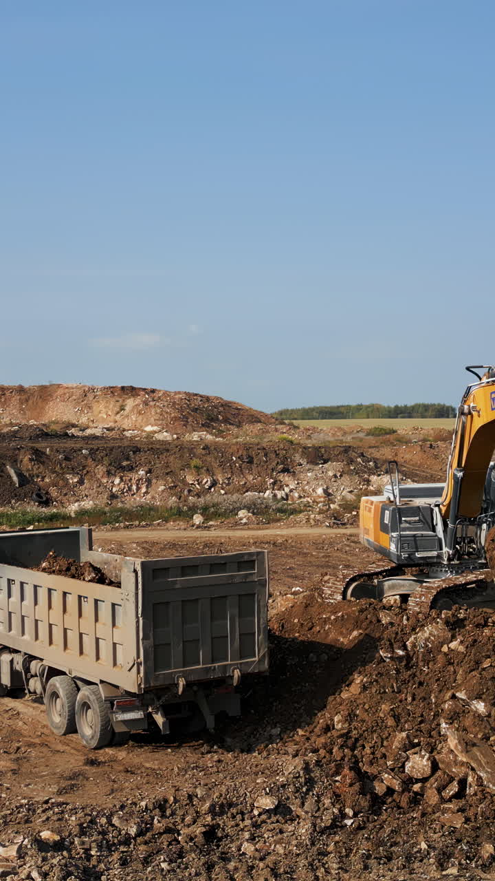 Heavy Equipment at Construction Site: Excavator Loading Dump Truck