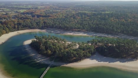 Aerial-drone-view-of-the-beautiful-small-island-in-the-middle-of-the-lake-in-the-tropical-paradise-looked-in-the-Netherlands,-Europe