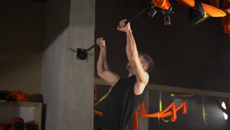 Man-pulling-up-on-horizontal-bar-at-crossfit-gym