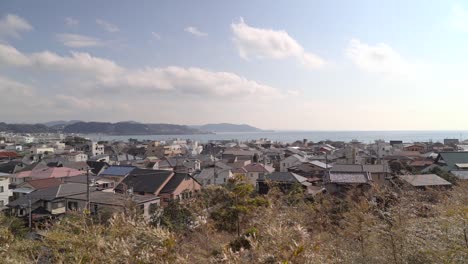 traditional japanese houses along the kamakura seaside in japan - slow motion wide shot