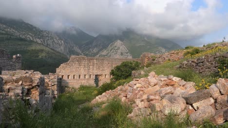 Ruins-of-old-fortress-at-sunset,-mountains-and-clouds,-Southern-Europe