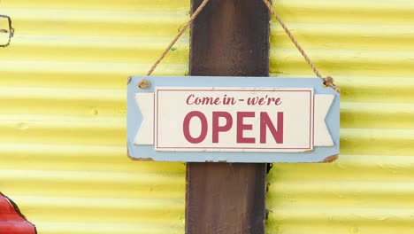 open sign on yellow wall