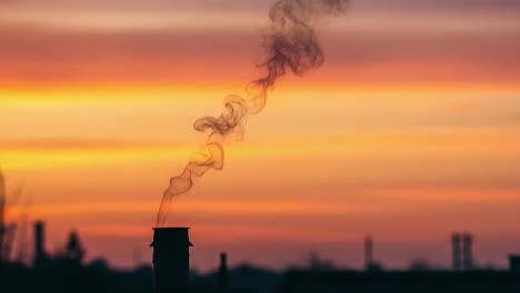 A Soothing Dawn Skyline: Wisps of Smoke Dancing Against a Colorful Sunrise, Capturing the Tranquility of Nature&#039;s Morning Palette