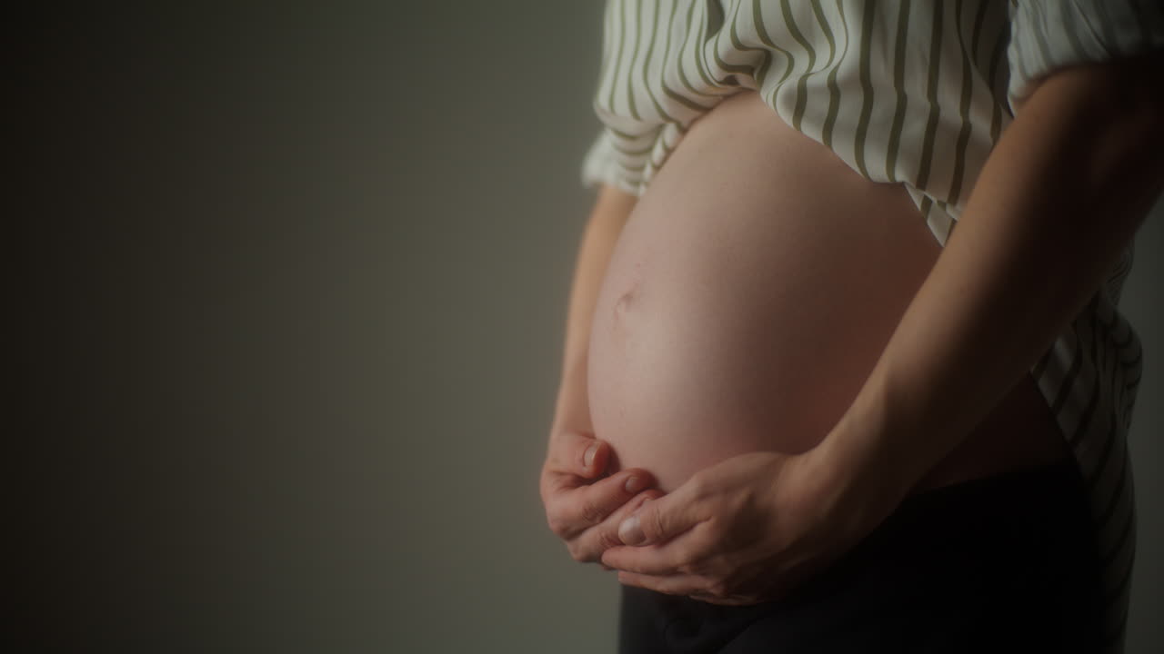Pregnant Woman Gently Rubs Her Belly