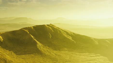 endless golden hills stretch across the horizon under a soft yellow sky